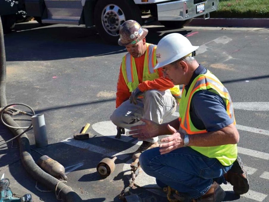 Crew prepping damaged pavement for repair