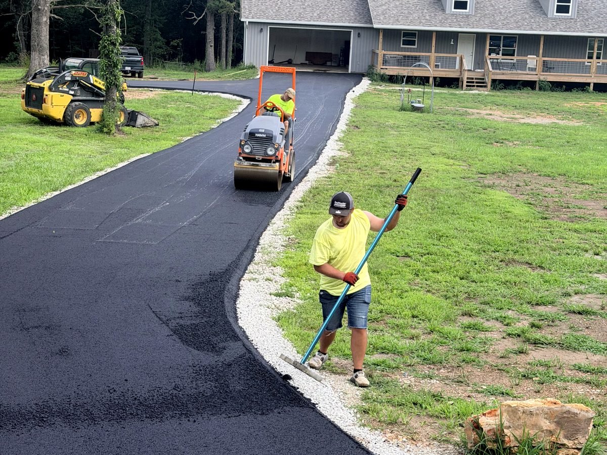 Our crew compacting a fresh asphalt driveway in the Springfield metro